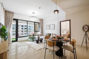 a living room with a table and chairs at Burj Khalifa Fireworks View Downtown - One Bedroom Apartment in Dubai