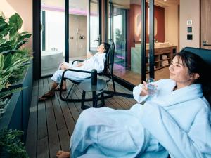 two women sitting in chairs in a hospital room at FAV LUX Sapporo Susukino in Sapporo