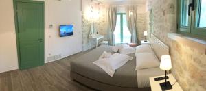 a bedroom with a large bed with white pillows at Bellou Villas Sivota in Syvota