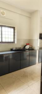 a kitchen with a black counter top in a room at Malabar Service Apartments in Cochin