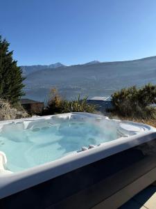 a jacuzzi tub with a view of the ocean at Queenstown Alpine Escape in Frankton Wharf