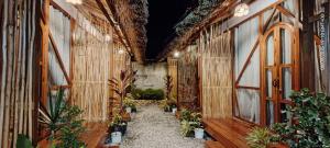 a hallway with plants on the walls of a building at Balay Hayahay Clohaki Hostel in General Luna +26 photos