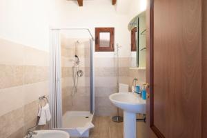ein Badezimmer mit Dusche, Toilette und Waschbecken in der Unterkunft Corte di Gallura in Budoni