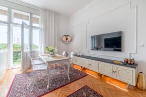 a dining room with a table and a tv at Apartment A.M.P. in Pula