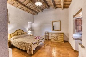 a bedroom with a bed and a dresser and a mirror at Masia Mas Tibau in Girona +35 photos