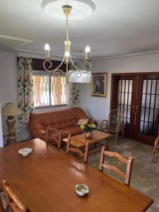 a living room with a couch and a table at La Barrosa - Chalet La Morenita in Chiclana de la Frontera