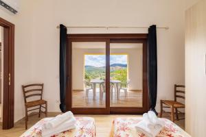 a room with a glass door with a table and chairs at Corte di Gallura in Budoni +18 photos