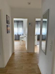 a hallway with two mirrors and a dining room at Ferienwohnung Landskrone in Oppenheim +5 photos