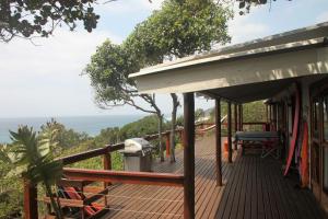 a deck of a house with a view of the ocean at Vila do Monte, Villa #8, Ponta Mamoli in Ponta Mamoli