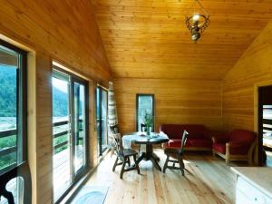 a room with a table and chairs in a cabin at Glola LakeFront in Glola