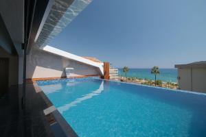 a swimming pool with a view of the ocean at Green Garden City Luxury Apartments in Alanya