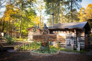 a log cabin with a sign in front of it at LAMP Nojiriko The Sauna by the Lake in Shinano