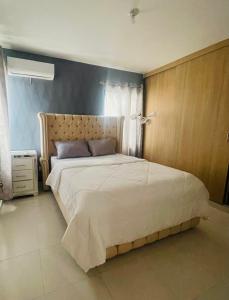 a bedroom with a large bed in a room at Casa de los Sueños - Santo Domingo in Los Paredones