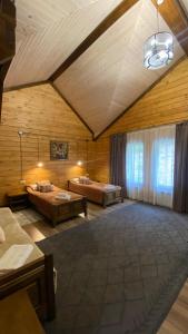 a large room with two beds and a ceiling at Риддер Тайга- Ridder Taiga 