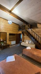 a large room with two beds and a staircase at Риддер Тайга- Ridder Taiga 