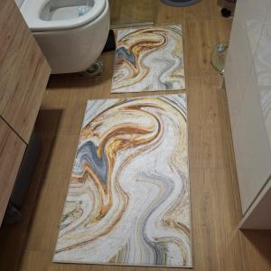 a bathroom with a swirl rug on the floor in a bathroom at CrystalLUS in Požega +11 photos