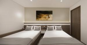 Ένα ή περισσότερα κρεβάτια σε δωμάτιο στο Saigon Nam Long Hotel