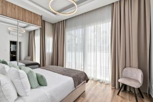 a bedroom with a large bed and a large window at Olymp White Palace - The Ultra Luxury Beach House in Kissonerga +75 photos