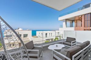 a balcony with a view of the ocean at Olymp White Palace - The Ultra Luxury Beach House in Kissonerga