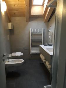a bathroom with a toilet and a sink at R&B La Calzoleria in Mori +46 photos