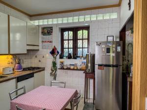 a kitchen with a stainless steel refrigerator and a table at Gondolas Home Stay in Ragama