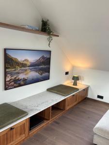 a living room with a large flat screen tv on a wall at Hvanndalir Lodge in Ólafsfjörður