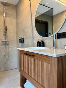 a bathroom with a sink and a mirror at Hvanndalir Lodge in Ólafsfjörður +36 photos