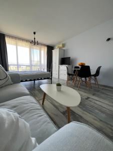 a living room with a couch and a table at Studio E32 Atia Resort Chernomoretz in Chernomorets