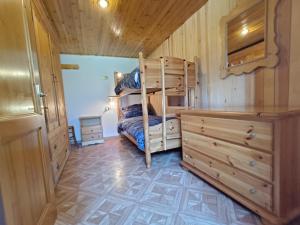 a bedroom with a bunk bed and a dresser at Coldemies apartment in Alleghe
