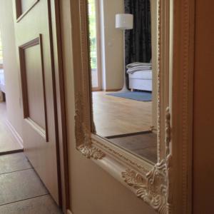a mirror on a door in a room at Fortuuna 5 Apartment in Tartu
