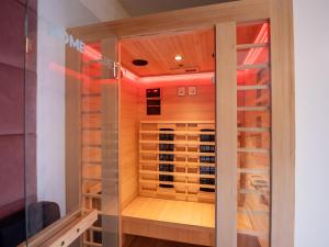 a wine cellar with a glass door in a room at 120 - Cristalys Love Room- Balnéo-Sauna infrarouge in Montpellier