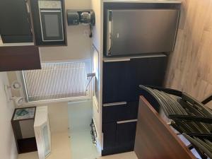 a small room with a staircase and a microwave at Mobil-home 4 Pers avec Terrasse à Limeuil - API-1-52-553 in Limeuil