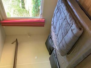 a bed in a small room with a window at Mobil-home 4 Pers avec Terrasse à Limeuil - API-1-52-553 in Limeuil