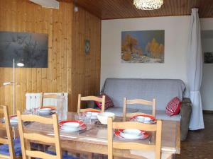 a dining room table with four chairs and a couch at Appartement 3 pièces 8 couchages proche des pistes à Vars Les Claux - FR-1-330B-222 in Vars