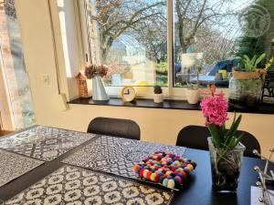 a table with colorful beads on it with a window at Gîte paisible avec jardin privé, cheminée et équipements modernes au cœur du Parc Naturel de l'Avesnois - FR-1-510-98 in Choisies