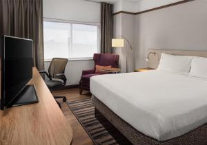 a hotel room with a bed and a tv at Hilton Garden Inn Minneapolis Airport Mall of America in Bloomington