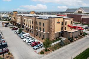 an aerial view of a building with cars parked in a parking lot at Comfort Suites Loveland in Loveland