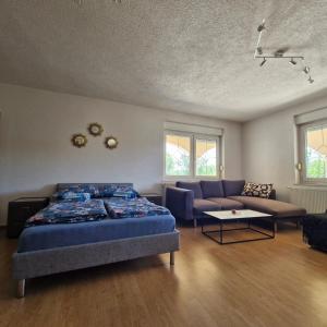 a bedroom with a bed and a couch at Family Apartment Miki in Teslic in Teslić