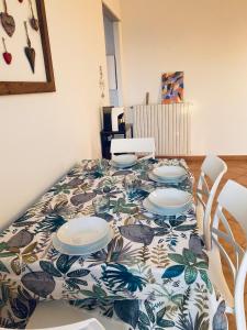 a dining room table with a patterned table cloth at Corte del Vigneto in Montemagno +20 photos