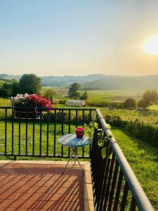 a table on a balcony with a view of a field at Corte del Vigneto in Montemagno