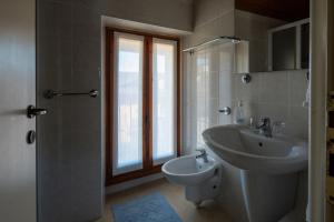 a bathroom with a sink and a toilet at Villa Toscanini in Stresa