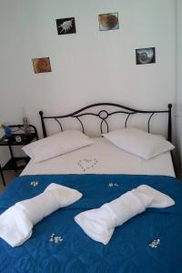 a bed with two pillows on top of it at Vigles in Adamas