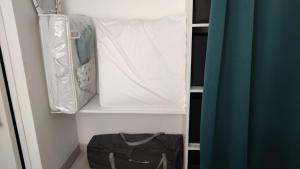 a closet with a bed and a bag in it at T2 West CITY Parking Clim Wifi 4pers - ROSSIconciergerie - Linge inclus in La Grande-Motte