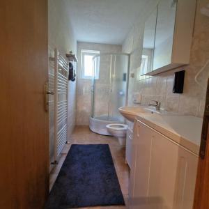 a bathroom with a toilet and a sink and a shower at Family Apartment Miki in Teslic in Teslić +33 photos