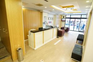an office lobby with a reception desk and chairs at Grand Karot Hotel in Yalova