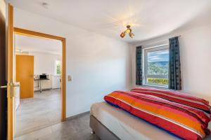 a bedroom with a bed and a window at Haus Eisele in Bad Urach