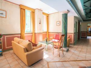 a living room with a couch and a table at Cozy Apartment with Swimming Pool, Terrace, Garden, Parking in Montbrun-les-Bains