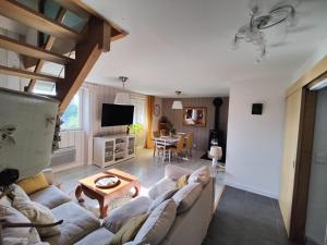 a living room with a couch and a table at Maison a salers in Salers