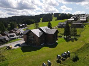 an aerial view of a house on a green field at Villa Erdődy Resort in Oravská Lesná