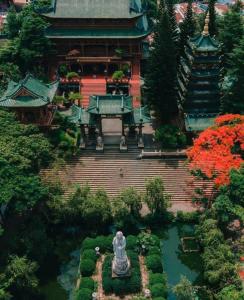 a large building with a fountain in a garden at Xom Camping in Plei Chuêt